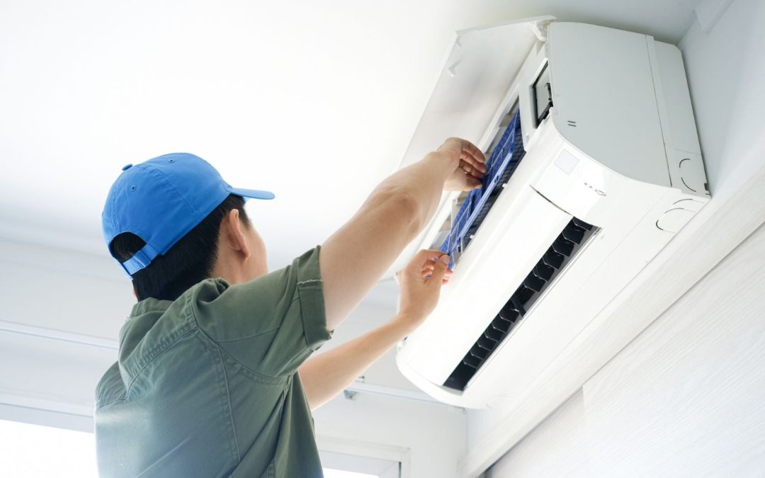 Air conditioning technician maintaining an indoor mini split system in Greeley, CO