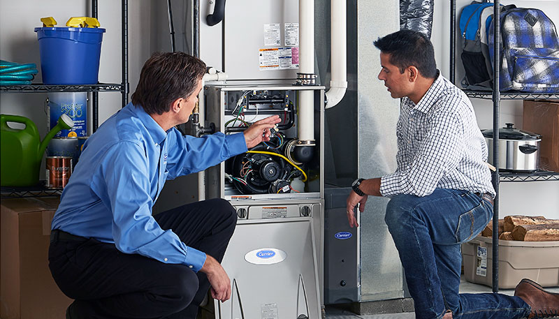 HVAC technician evaluating a furnace for repair or replacement in Greeley