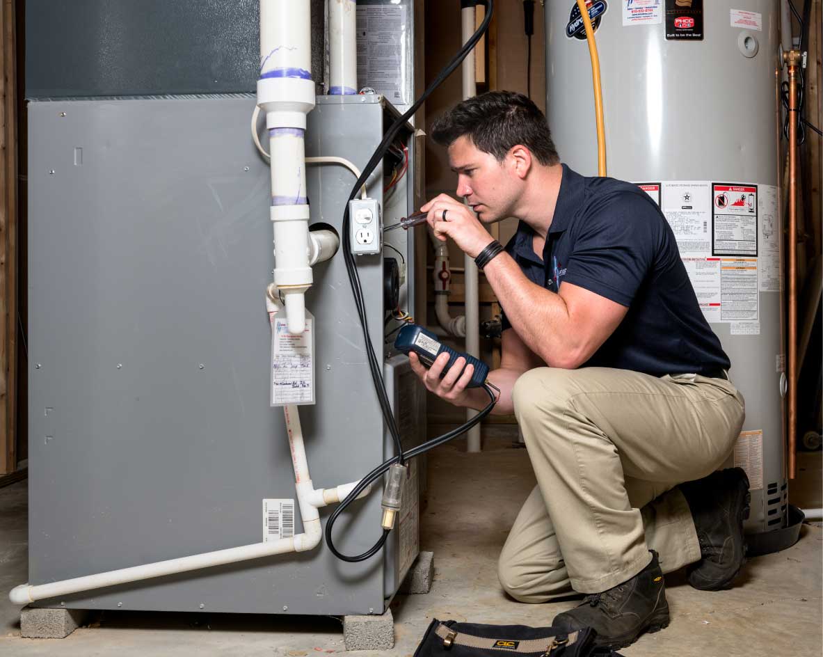HVAC technician performing a furnace tune-up in Greeley