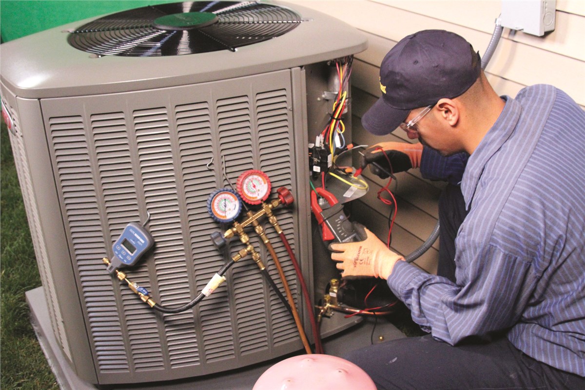 HVAC technician testing an outdoor air conditioning unit in Greeley